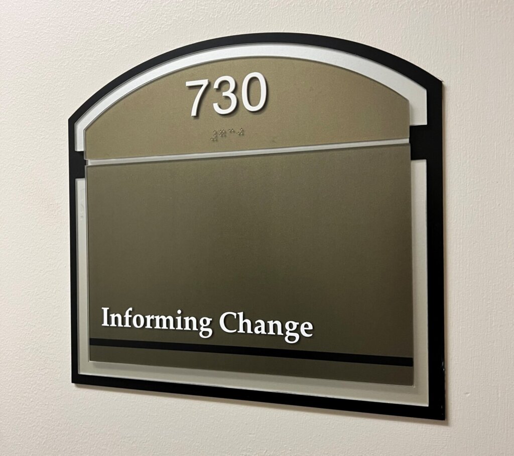Sign outside of our office with 730 (suite number) and Informing Change